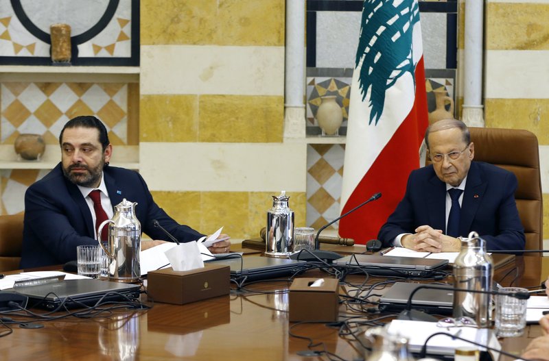 Lebanese President Michel Aoun, right, meets with Prime Minister Saad Hariri, during the first meeting of the Lebanese cabinet at the Presidential Palace in Baabda, east of Beirut, Lebanon, Saturday, Feb. 2, 2019. The new Cabinet was announced Thursday night breaking a nine-month deadlock that had deepened Lebanon's economic woes. (AP Photo/Bilal Hussein)