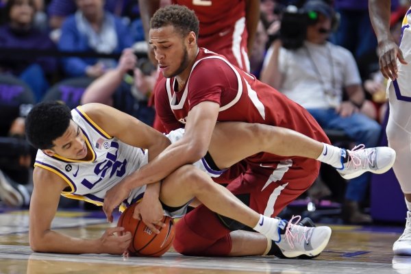 LSU guard Tremont Waters (3) and Arkansas forward Daniel Gafford (10) scramble for the ball during the first half of an NCAA college basketball game Saturday, Feb. 2, 2019, in Baton Rouge, La. (AP Photo/Bill Feig)