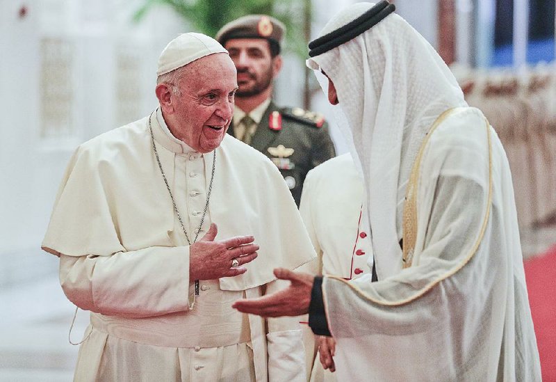 Pope Francis is greeted by Sheikh Mohammed bin Zayed Al Nahyan, Abu Dhabi’s crown prince, after the pontiff’s arrival Sunday in the United Arab Emirates. 