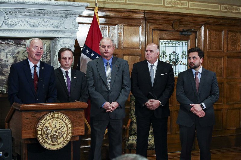 FILE - Gov. Asa Hutchinson (left) is joined by House Speaker Matthew Shepherd on Jan. 30 as he announces his “5.9 plan” for cutting income-tax rates. 