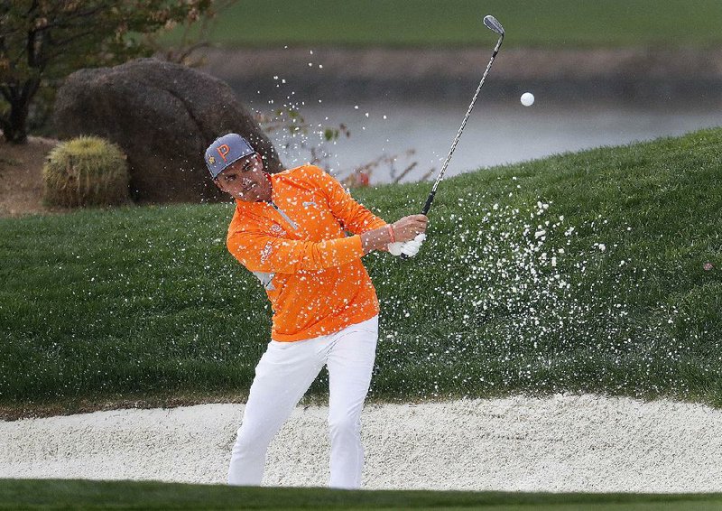 Rickie Fowler hits from the bunker on the 12th green during the final round of the Phoenix Open on Sunday in Scottsdale, Ariz. Fowler shot a 3-over 74 Sunday to finally win the tournament that had twice eluded him.