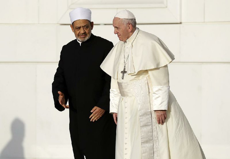 Sheikh Ahmed el-Tayeb (left), grand imam of Egypt’s Al-Azhar Mosque, talks with Pope Francis on Monday in Abu Dhabi, United Arab Emirates, before a private meeting with members of the Muslim Council of Elders. 