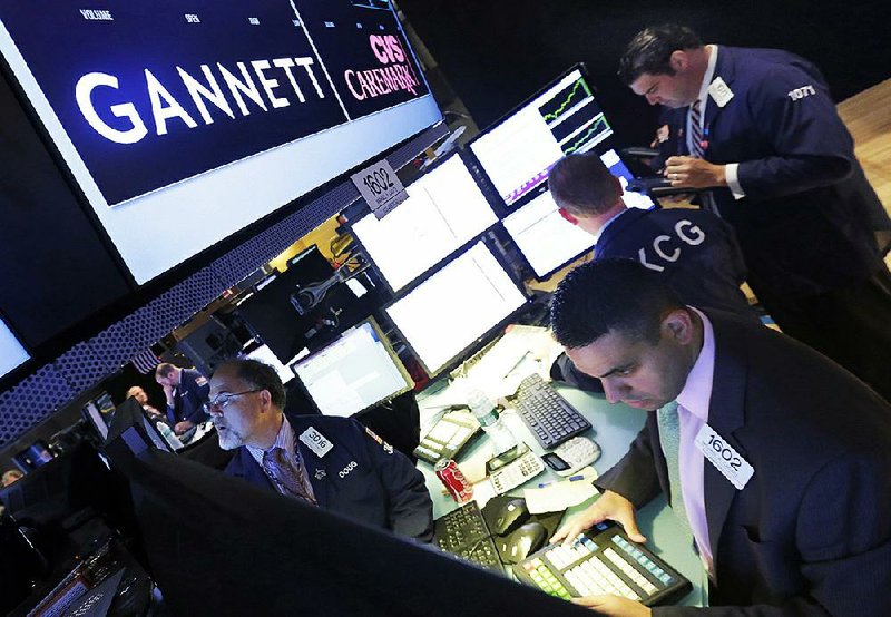 A trader works at the post that handles Gannett on the floor of the New York Stock Exchange in 2014. Gannett, publisher of USA Today, has rejected a buyout offer.