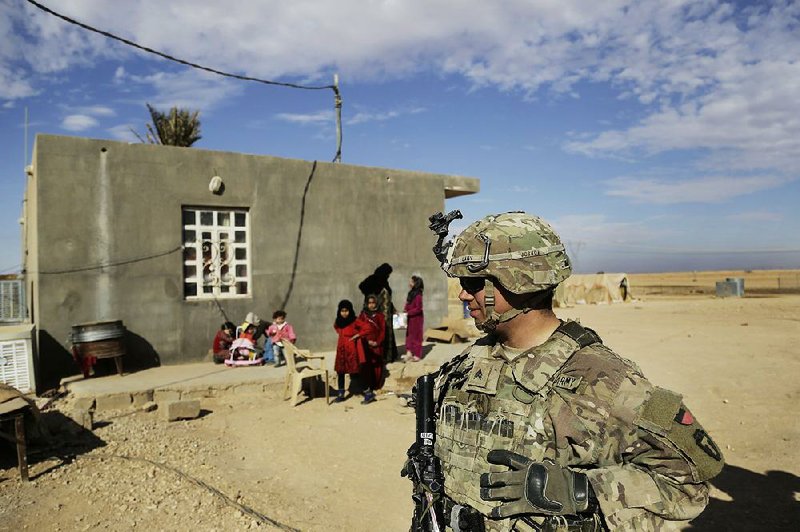 U.S. Army soldiers speak to families in rural Anbar on a reconnaissance patrol near a coalition outpost in western Iraq, in January 2018. 