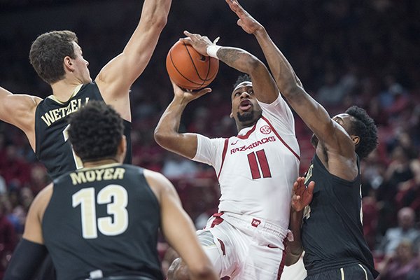 Arkansas guard Keyshawn Embery-Simpson goes up for a shot between three Vanderbilt defenders on Tuesday, Feb. 5, 2019, in Fayetteville. 