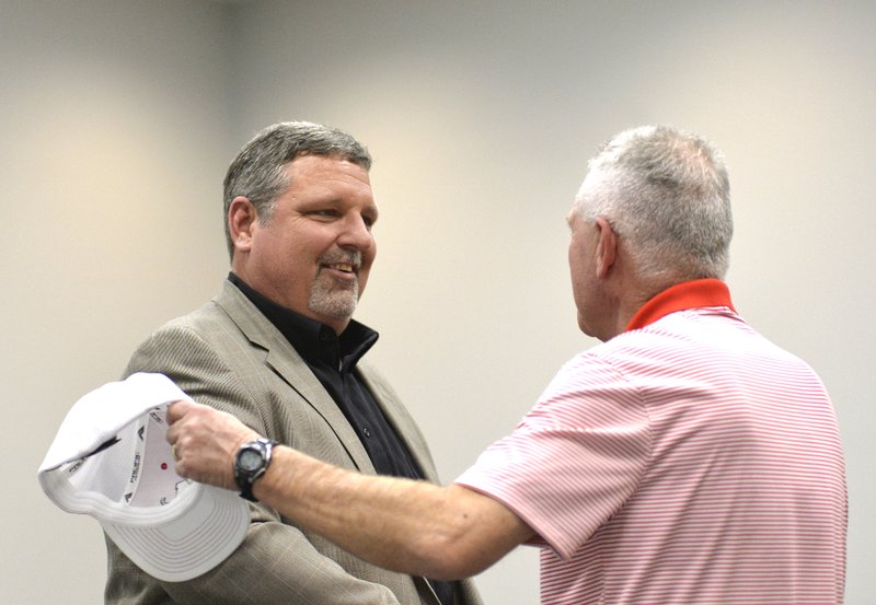 Coach Mark King (left) shakes hands with Magnolia Athletic Director Marvin Lindsey after being introduced Monday as new Panther head football coach. 
