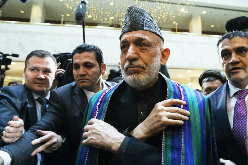 Hamid Karzai (second from right), the former president of Afghanistan, arrives Tuesday for talks with Taliban representatives in Moscow. 