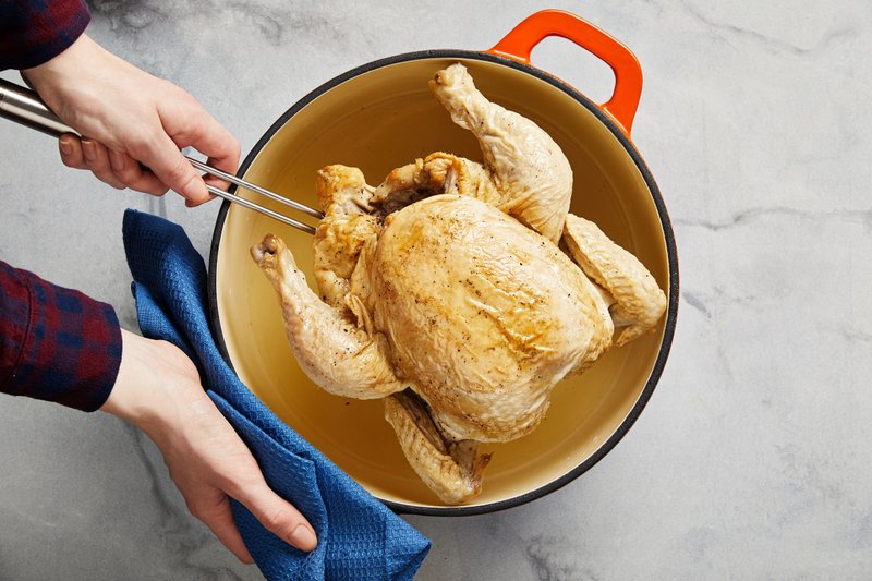 Overnight poached chicken comes out straw gold on top with an almost creamily luscious broth surrounding it. MUST CREDIT: Photo for The Washington Post by Tom McCorkle; food styling by Lisa Cherkasky