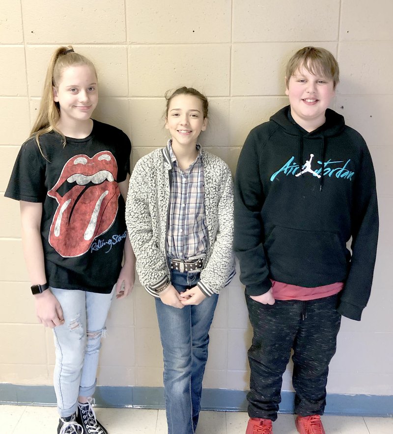 COURTESY PHOTO Raeleigh Meyer, Shelby Earnheart and Charles Bublitz, students at Farmington Junior High, made a presentation to the School Board last week, recommending the district install speed bumps in the parking lot in front of the administration building.