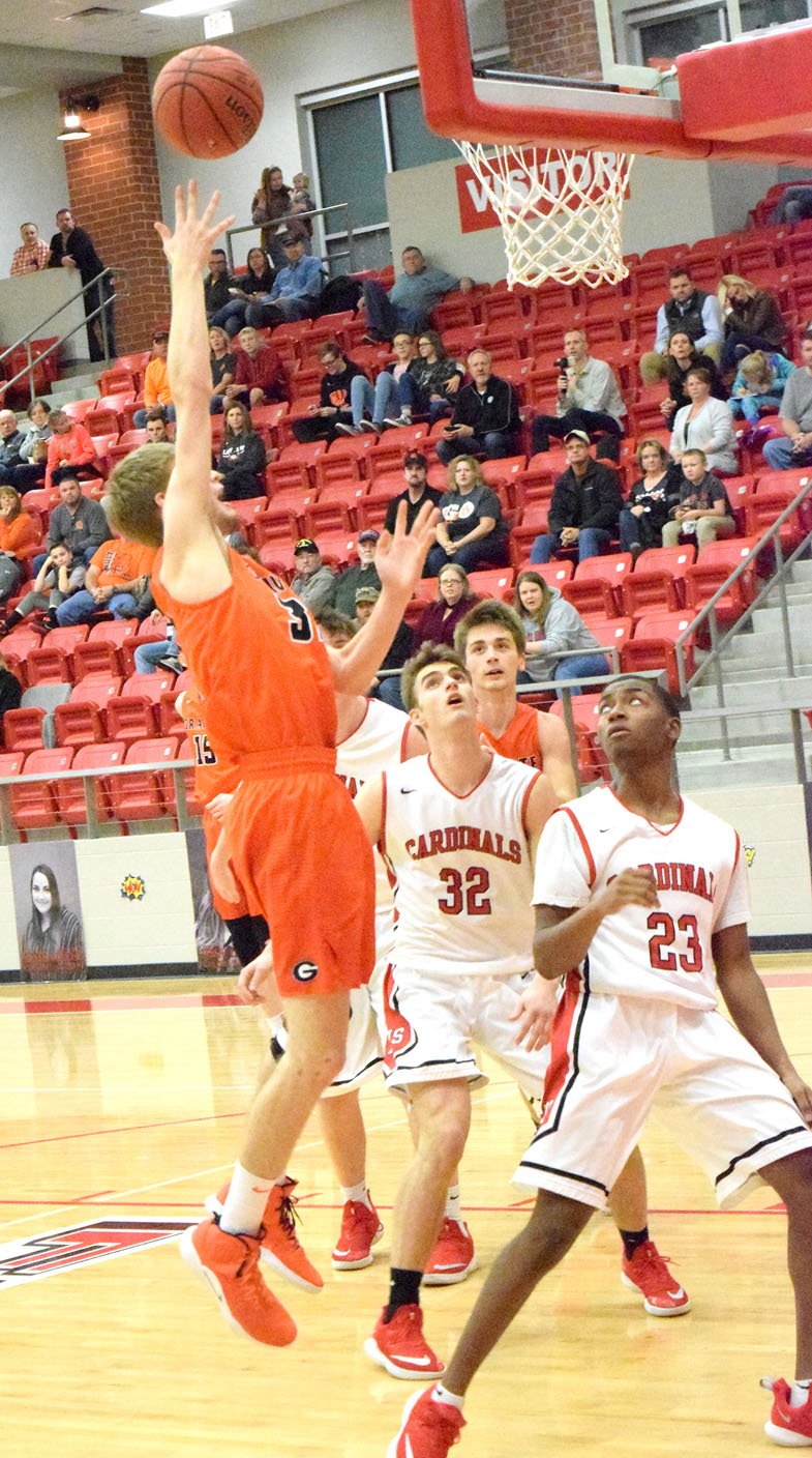 Westside Eagle Observer/MIKE ECKELS Brayden Trembly (Gravette 33 left) puts up a jumper over Cardinals' William Pridmore (32) and Jayden Whitmore (23) during the third quarter of the Farmington-Gravette game in Farmington Feb. 1.The Lions took the conference win over the Cardinals, 55-44.