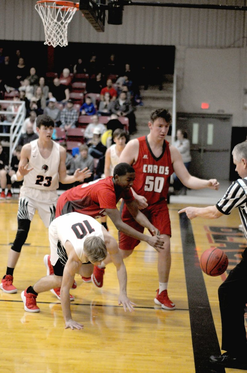 MARK HUMPHREY ENTERPRISE-LEADER/The referee is right on top of the action signaling who the basketball was last touched by as it goes out-of-bounds during a scramble in a Tuesday, Jan. 29 conference game between Farmington and Pea Ridge. The Cardinals held off the Blackhawks, 46-44, to wrap up the top seed in the 4A-1 West Division and gain a berth into the Regional tournament.