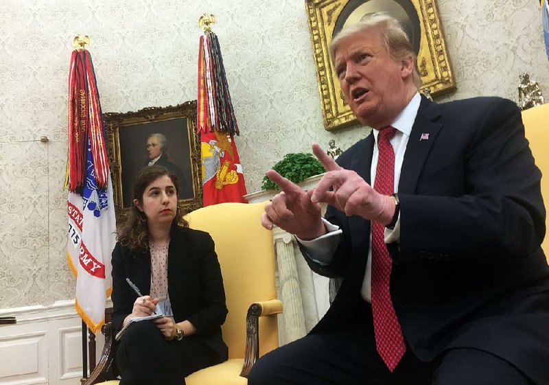President Donald Trump meets Wednesday in the Oval Office with reporters, including Tamar Hallerman(left) of the Atlanta Journal-Constitution. Among topics he discussed was Arkansas’ U.S. Sen. Tom Cotton, who Trump said he’d been on the phone with just before the press session. 