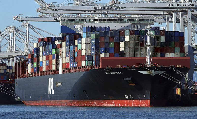 Crews unload container ships in December at the Port of Oakland in California. The U.S. trade deficit narrowed in November by more than forecast, the Commerce Department reported. 