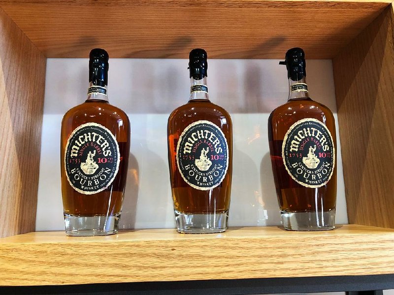 Bottles of bourbon sit on display last month at Michter’s distillery in Louisville, Ky. The bourbon industry’s economic output in Kentucky increased 60 percent in the past decade, a new study says. 
