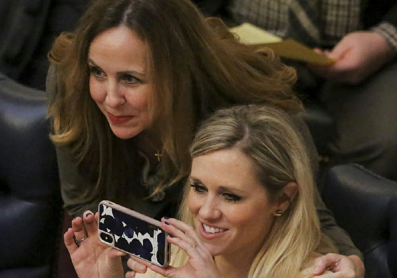 Sen. Breanne Davis (right) captures the moment Tuesday with Sen. Missy Irvin after the Senate approved a bill by Davis clarifying the approval process for Amendment 100. 