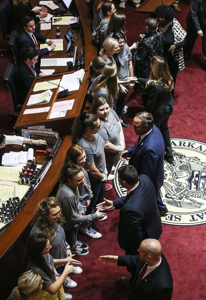 Members of the state Senate congratulate the Paris High School  volleyball  team  on  winning  the  Class  3A  state  championship  during the players’ visit to the state Capitol on Wednesday. 