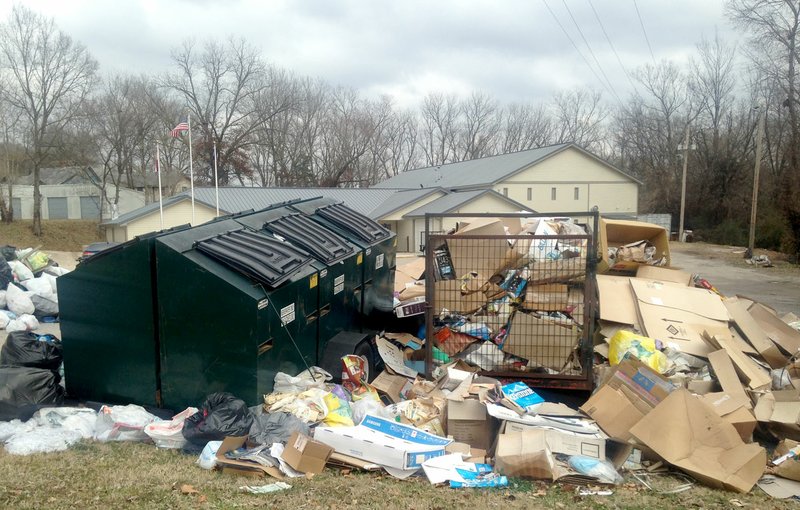 Sally Carroll/McDonald County Press Recyclables pile up behind the McDonald County Courthouse in Pineville. A grant currently enables McDonald County commissioners to hire someone to transport the items to the Neosho Recycling Center. Two piles of items remain, however, and a sign near the sight asks McDonald County neighbors not to drop off any more recyclable items.