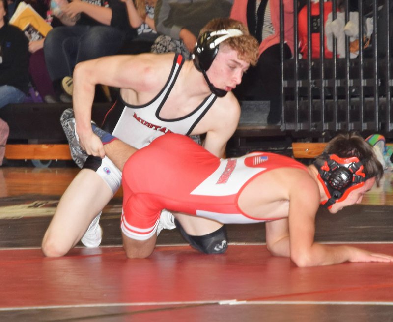 RICK PECK/SPECIAL TO MCDONALD COUNTY PRESS Defending state champion Oscar Ortiz clinched McDonald County's 45-36 win over Carl Junction on Jan. 31 at MCHS with a pin over Carl Junction's Silas Walker.