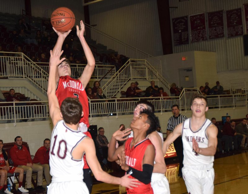 RICK PECK/SPECIAL TO MCDONALD COUNTY PRESS McDonald County's Cale Adamson shoots over East Newton's Austin Brewer during the Mustangs' 60-58 loss on Feb. 1 at East Newton High School.