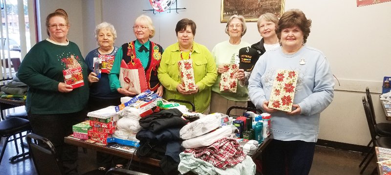Submitted photo DAV Gifts: From left, Hot Springs Chapter 80 United Daughters of the Confederacy members Ozella Willingham, Margie Hill, Cortez Copher, Barbara Erdmann, Rita Byram, Martha Koon and Cynthia Matthews wrapped gifts for the DAV luncheon at Smokin' In Style BBQ. T-shirts, underwear, socks, puzzles, word games, drawing tablets, coloring books, toiletries, military caps, and blankets were wrapped then delivered to the head of the local DAV representatives for him to distribute. This was the second year of this ongoing project that the chapter loves to do.