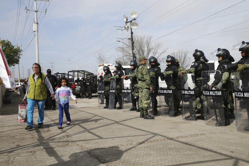 A woman arrives with donations at a shelter housing Central American immigrants in Piedras Negras, Mexico, Tuesday, Feb. 5, 2019. A caravan of about 1,600 Central American migrants camped Tuesday in the Mexican border city of Piedras Negras, just west of Eagle Pass, Texas. (Jerry Lara/The San Antonio Express-News via AP)