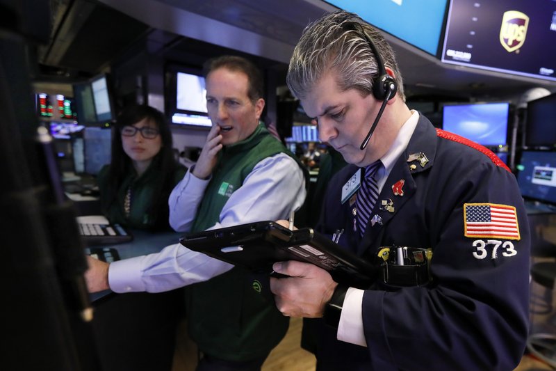 FILE- In this Tuesday, Jan. 29, 2019, file photo specialist Specialist Glenn Carell, center, and trader John Panin work on the floor of the New York Stock Exchange. The U.S. stock market opens at 9:30 a.m. EST on Thursday, Feb. 7. (AP Photo/Richard Drew, File)

