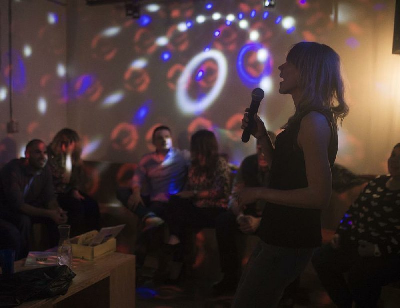 Cher Evans of Bentonville performs last month at Big Box Karaoke in Fayetteville.