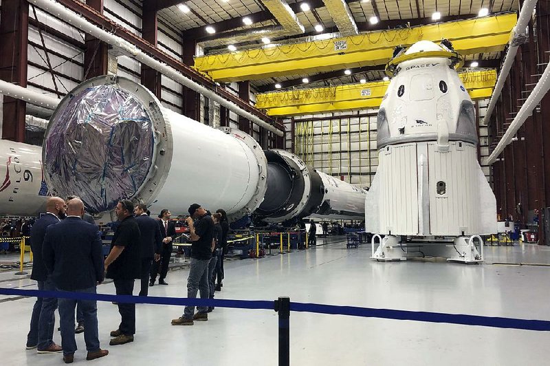 SpaceX’s Dragon capsule (right) sits in a SpaceX hangar in Cape Canaveral, Fla., in December. 