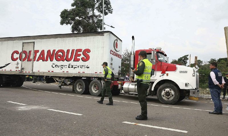 A truck hauling humanitarian aid from the U.S. to Venezuela arrives Thursday at the International Bridge Tienditas near Cucuta, Colombia, at the Venezuela border. 
