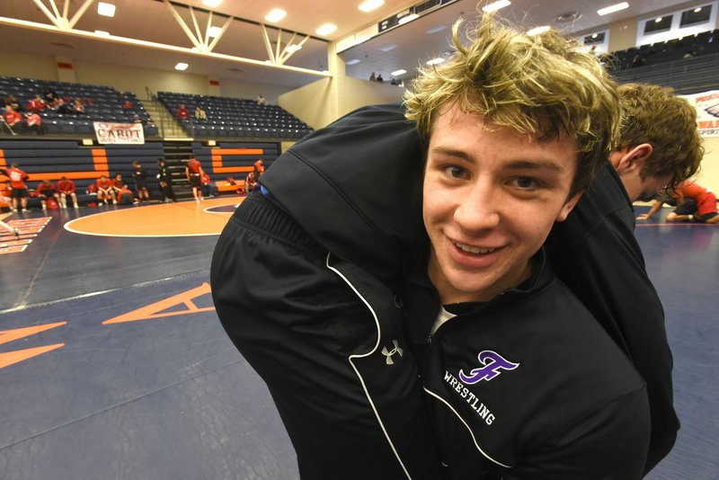 NWA Democrat-Gazette/FLIP PUTTHOFF Matthew Muller, shown warming up with a teammate before last weekend's Class 6A dual state tournament, will be looking to tune-up the upcoming state tournament in Saturday's Big West Conference wrestling tournament at Bulldog Arena in Fayetteville.