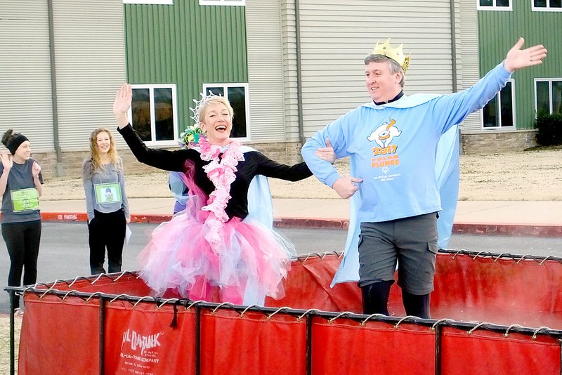 Lynn Atkins/The Weekly Vista Assistant Principal Rachel Manus and Principal Chad Mims start the 2019 Polar Plunge in front of Cooper Elementary School on Friday morning with a temperature of 13 degrees. Because of the weather, students watched from inside while about two dozen teachers, administrators, staff members and fire fighters took the plunge to raise money for Special Olympics.