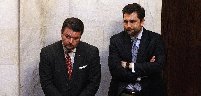 State Rep. Jason Rapert (left) and Sen. Jonathan Dismang listen to debate in the Senate on Thursday on Rapert’s bill to ban abortions in Arkansas if the U.S. Supreme Court overturns Roe v. Wade or the U.S. Constitution is amended to allow states to do so. The debate elicited emotional gasps and tears before the Senate approved the measure and sent it to the House.