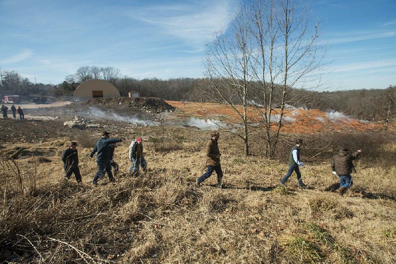 Federal and state officials view conditions Friday at the stump dump site in Bella Vista. 