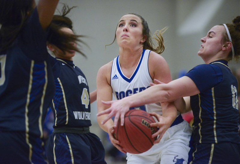 NWA Democrat-Gazette/CHARLIE KAIJO Rogers High School guard Courtney Storey (2) drives the ball for a layup during a basketball game, Friday, February 8, 2019 at Rogers High School in Rogers.