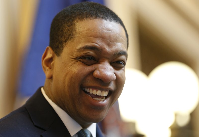 Virginia Lt. Gov Justin Fairfax smiles during the senate session at the Capitol in Richmond, Va., Thursday, Feb. 7, 2019. A California woman has accused Fairfax of sexually assaulting her 15 years ago. (AP Photo/Steve Helber)