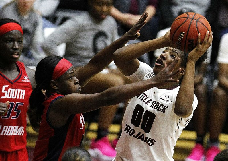 UALR senior Ronjanae DeGray (right) shoots while being defended by South Alabama junior Christen Carter during Saturday’s game at the Jack Stephens Center in Little Rock. 