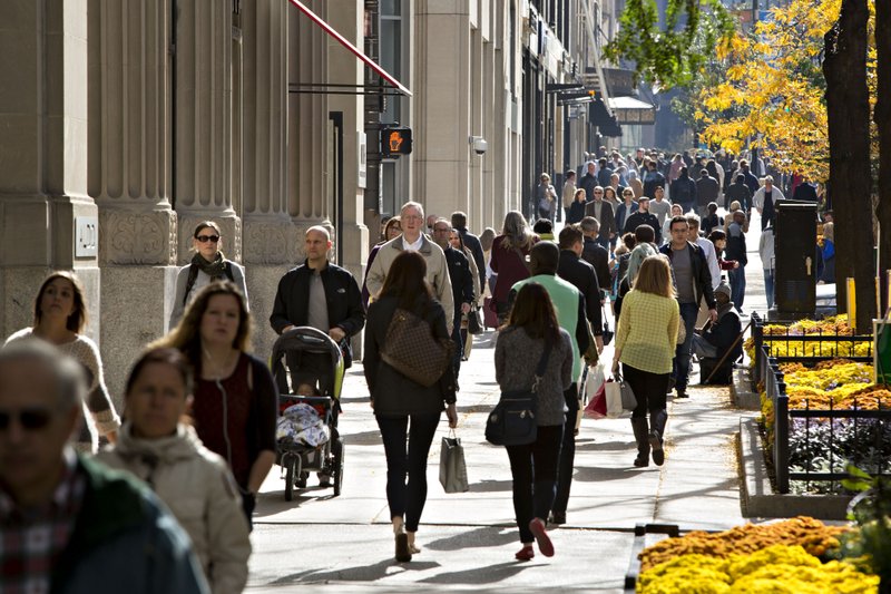 Shoppers walk past retail stores along the Magnificent Mile shopping district of Chicago. MUST CREDIT: Daniel Acker, Bloomberg