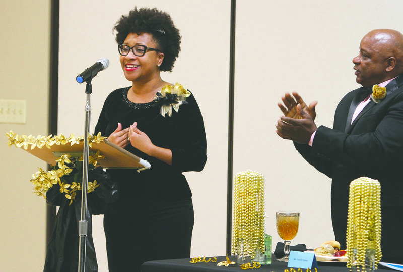 Honoree David Taylor, right, applauds as El Dorado Mayor Veronica Smith-Creer delivers the keynote speech during the fifth annual Black History Person of the Year and Youth of the Year Dinner Saturday at St. Mary's Episcopal Church. 