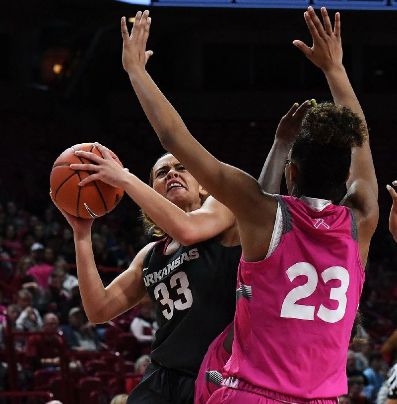 Arkansas sophomore guard Chelsea Dungee tries to shoot while Auburn’s Crystal Primm defends Sunday at Walton Arena in Fayetteville. Dungee had 41 points in the Razorbacks’ 75-72 loss to the Tigers.