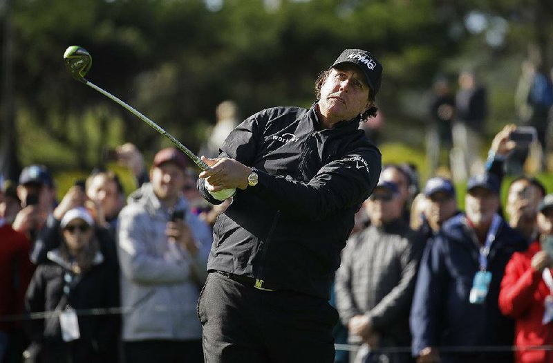 Phil Mickelson leads Scott Stallings and Paul Casey by three strokes with two holes to play at the AT&T Pebble Beach Pro- Am. Mickelson will finish his round today after weather delayed Sunday’s final round.