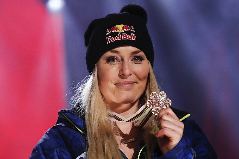 Lindsey Vonn of the United States shows her bronze medal after the final race of her career at the women’s downhill race Sunday at the alpine ski world championships in Are, Sweden.