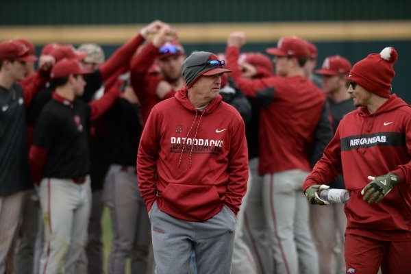 Arkansas coach Dave Van Horn walks back to the dugout after speaking to his players Friday, Jan. 25, 2019, during practice at Baum Stadium in Fayetteville.