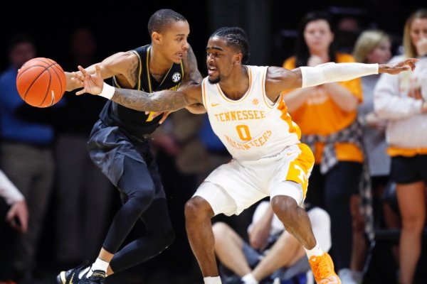 Tennessee guard Jordan Bone (0) attempts to steal the ball from Missouri guard Xavier Pinson (1) during the first half of an NCAA college basketball game Tuesday, Feb. 5, 2019, in Knoxville, Tenn. (AP photo/Wade Payne)