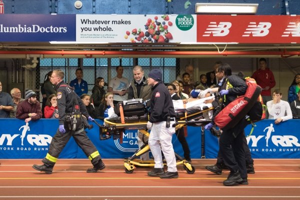 Emergency Service personnel remove Kemoy Campbell, of Jamaica, from the track after he collapsed during his duty as a pacesetter in the men's 3000-meter race at the Millrose Games track and field meet, Saturday, Feb. 9, 2019, in New York. (AP Photo/Mary Altaffer)