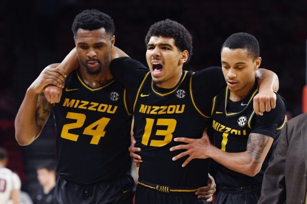 Missouri guard Mark Smith (13) is helped off the court by teammates Kevin Puryear (24), and Xavier Pinson (1) after he hurt his ankle playing against Arkansas during the second half of an NCAA basketball game, Wednesday, Jan. 23, 2019 in Fayetteville, Ark. (AP Photo/Michael Woods)