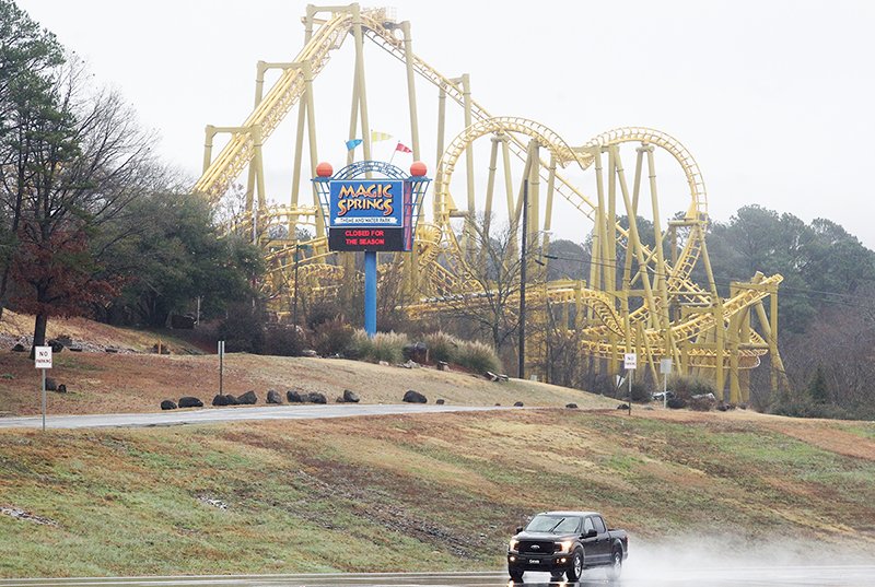 The Sentinel-Record/Richard Rasmussen NOW HIRING: A motorist drives past the main entrance to Magic Springs Theme and Water Park, 1701 E. Grand Ave., Monday morning. The park is getting ready to reopen to the public and is in the process of hiring employees, with the first of several job fairs scheduled for 4-7 p.m. today.