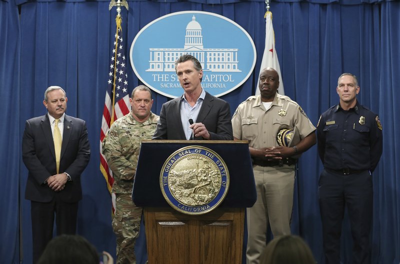 California Gov. Gavin Newsom, center, discusses his decision to withdraw several hundred National Guard troops from the nation's southern border and changing their mission, during a Capitol news conference Monday, Feb. 11, 2019, in Sacramento, Calif. Newsom, accompanied by from left, Mark Ghilarducci, director of the California Governor's Office of Emergency Services, Maj. Gen. David Baldwin, the Adjutant General of the California Military Department, Warren Stanley, Commissioner of the California Highway Patrol, right, and Thom Porter, director of the California Department of Forestry and Fire Protection, right, said he will order the troops to leave by the end of March but will leave 100 troops to focus on drug trafficking. (AP Photo/Rich Pedroncelli)