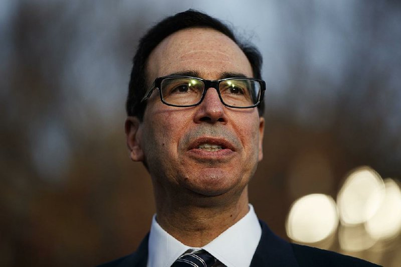 In this Dec. 3, 2018, file photo, Treasury Secretary Steven Mnuchin talks with reporters at the White House, in Washington.