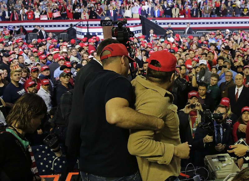 A man is restrained Monday after he attacked a BBC cameraman  during President Donald Trump’s rally Monday night in El Paso,  Texas. 