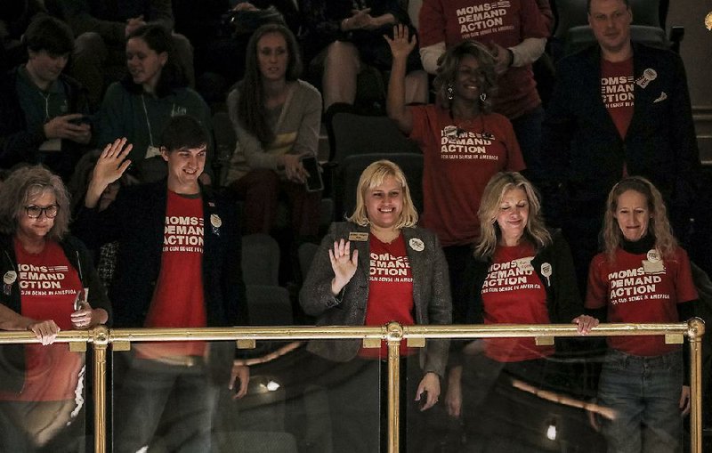 Members of Moms Demand Action For Gun Sense in America acknowledge applause from lawmakers Tuesday as they fill the gallery of the state House. 
